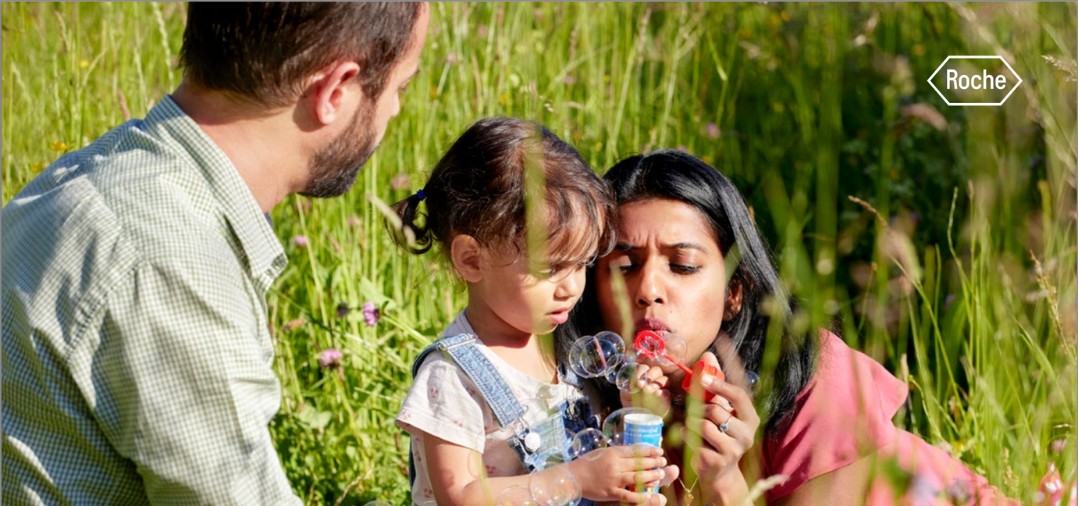 Family in a field, representing patient-centric storytelling for a healthcare sustainability report